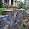 A masonry stone fence near the house.